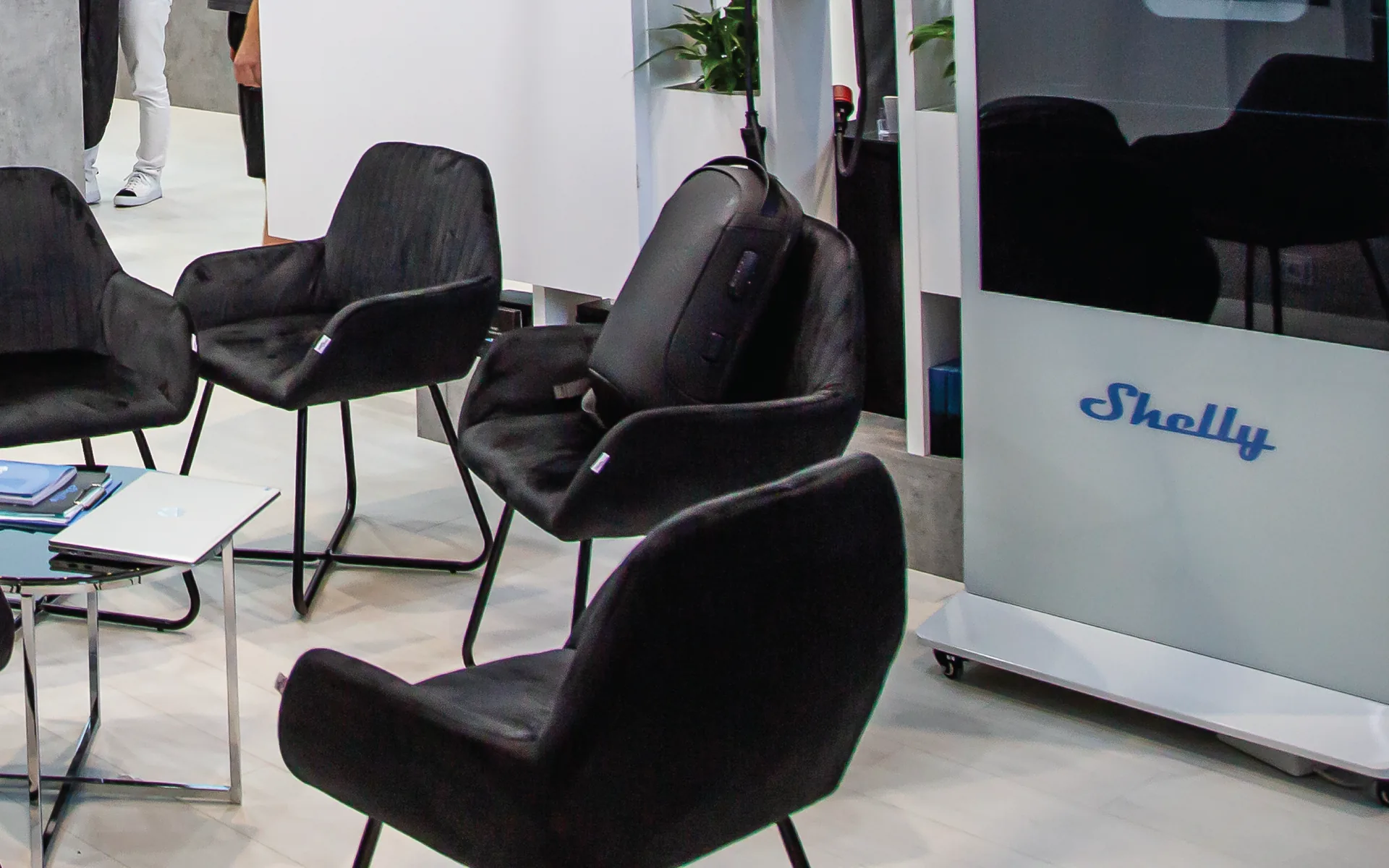 Event chairs and an interactive display arranged at an exhibition stand