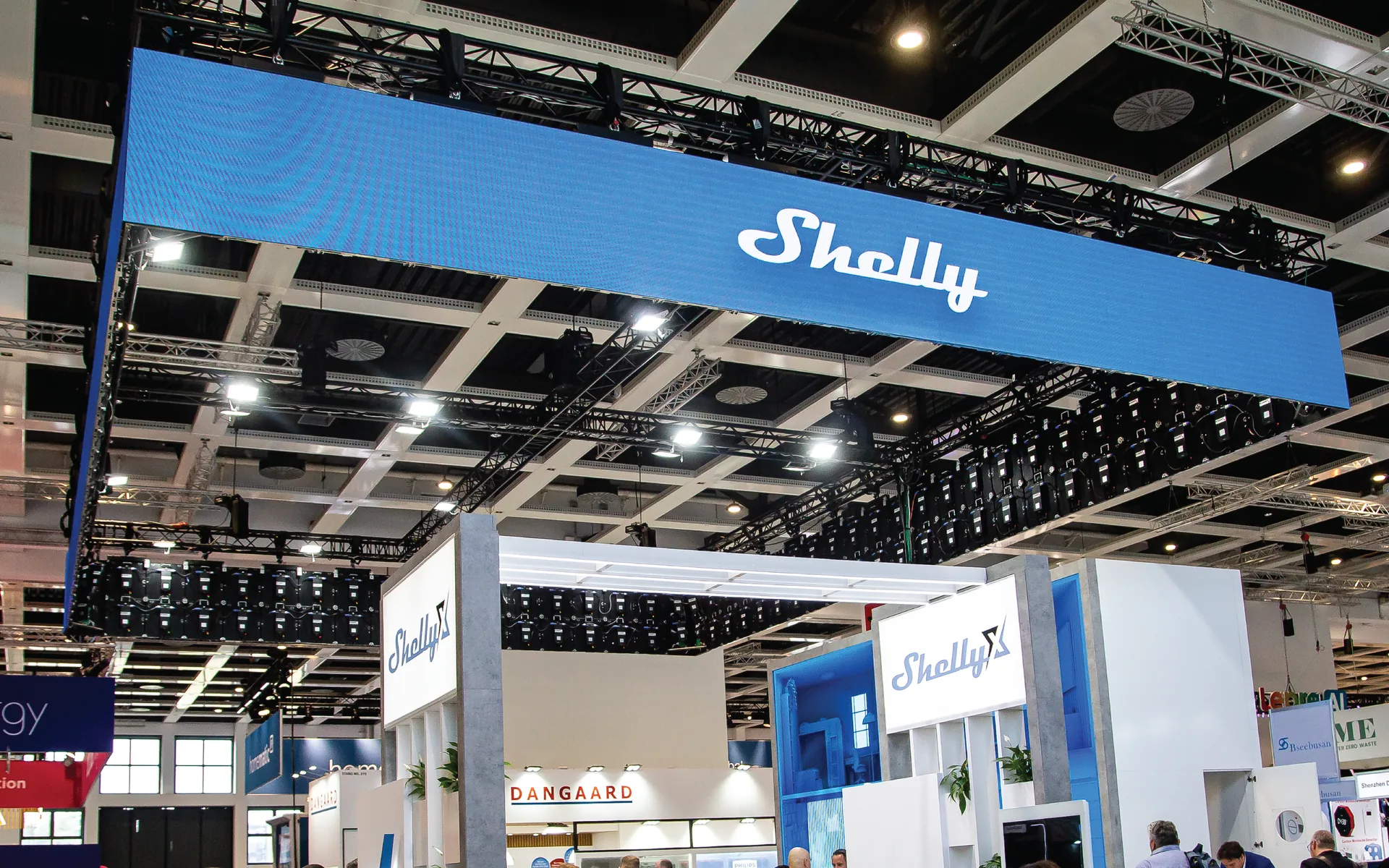 Overhead LED display installed above a trade show exhibition stand