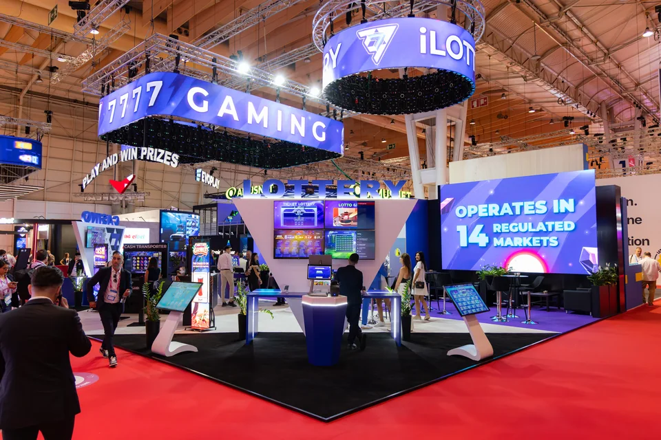 7777 Gaming exhibition stand with suspended circular LED displays at SBC Summit Lisbon 2025